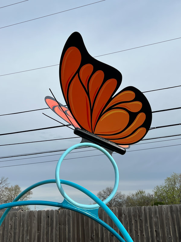giant metal butterfly on a metal hoop