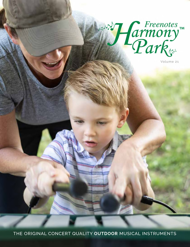 Freenotes Harmony Park Digital Catalog cover image with a child playing an outdoor musical instrument with the help of an adult